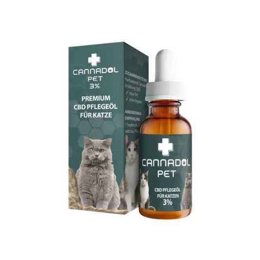 Cannadol Pet 3% CBD Pflegeöl für Katzen mit 300 mg CBD, 10-ml-Braunglasflasche mit weißer Pipette neben der grünen Faltschachtel mit Katzenmotiv
